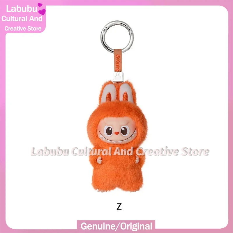 An orange fluffy Labubu plush doll with long ears is attached to a silver keyring.