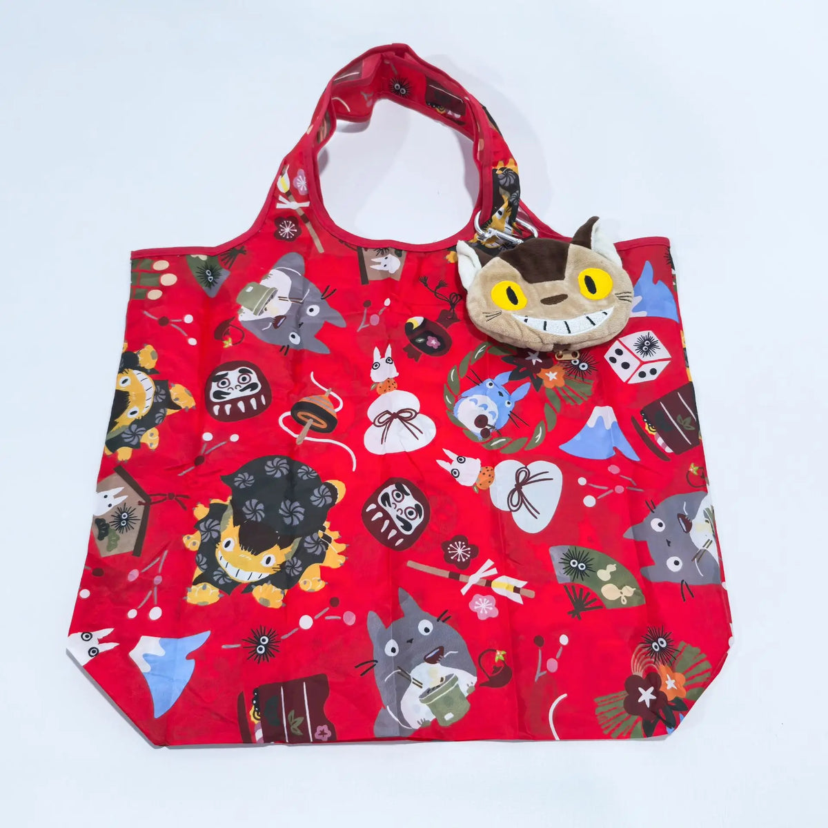 A red fabric bag featuring various cute animal designs and patterns, likely a plush toy storage item.