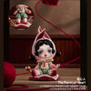 A porcelain heart collectible figure with dark hair and blue eyes sitting on a pink base.