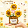 Handmade crochet sunflower bouquet with a motivational card presented in a hand.