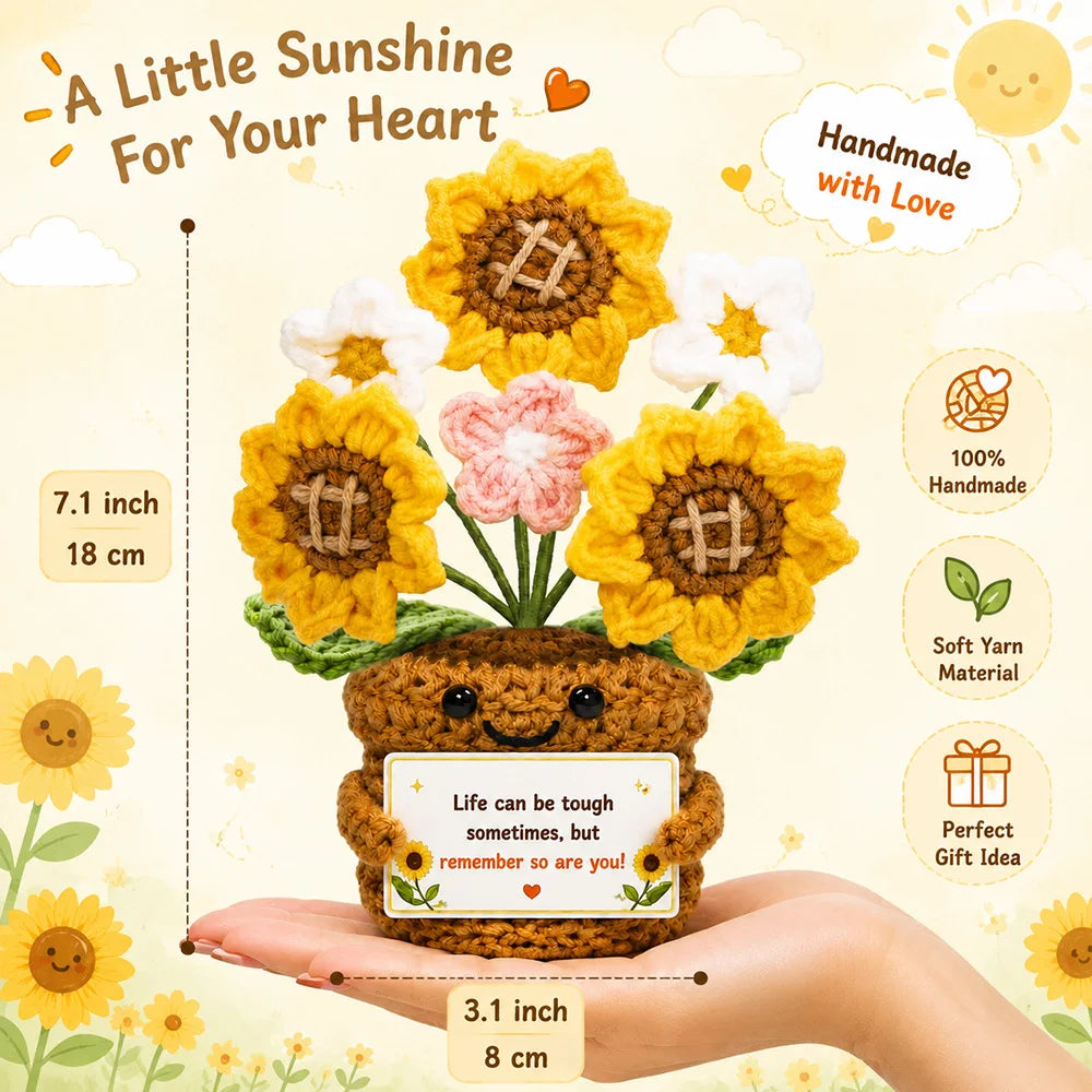 Handmade crochet sunflower bouquet with a motivational card presented in a hand.