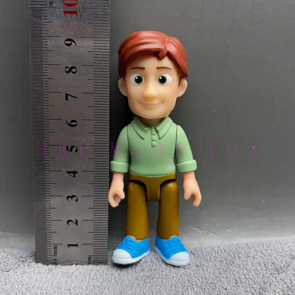 A playful cartoon PVC figurine of a boy with reddish hair wearing a green shirt and brown pants.