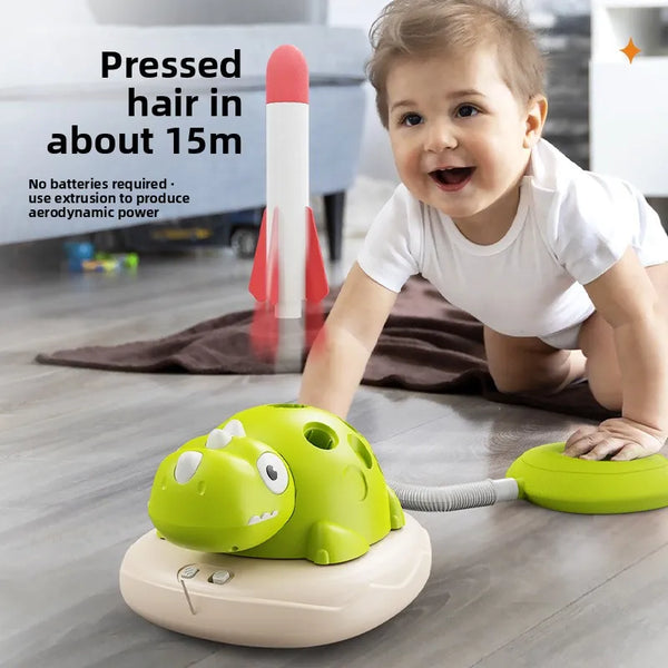 A baby is interacting with a green dinosaur-shaped training set for hair extrusion.