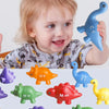 A toddler is holding a blue dinosaur toy while various colored dinosaur alphabet letters are displayed below.
