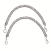 A sparkling rhinestone purse strap for handbags, featuring a curved design and dangling charms.