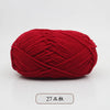 A ball of bright red pre-dyed milk cotton yarn used for knitting and crochet.