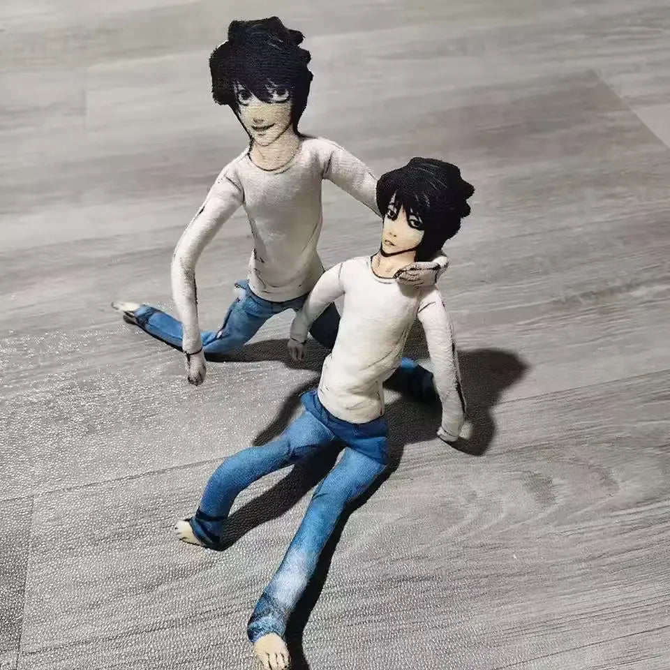 A pair of poseable plush dolls resembling L Lawliet from Death Note, featuring dark hair and blue clothing.