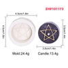 White silicone mold and dark purple candle with a gold pentagram design