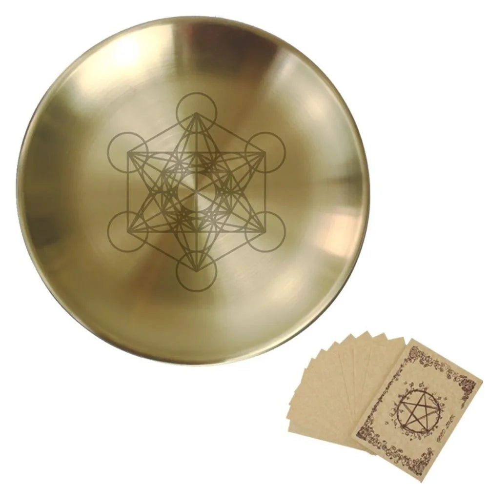 A round, brass-colored altar plate featuring an etched pentagram design.