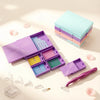 A modular diamond painting organizer with 38 slots and dot pens in purple and pink colors is shown on a light background.