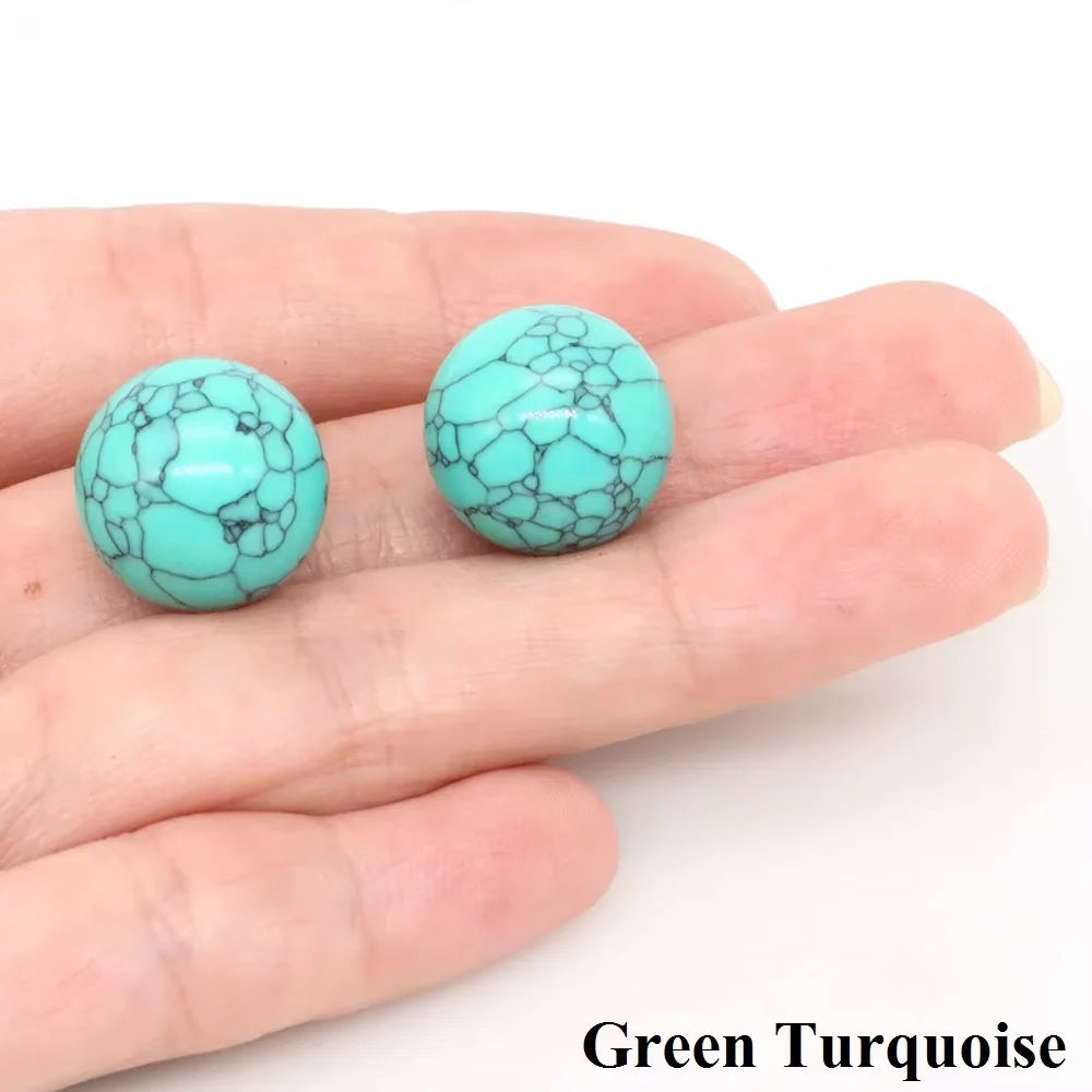 A hand holds a bright green turquoise crystal sphere on a white background.