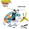 A metal model kit of an off-road vehicle or excavator, featuring silver and green components.