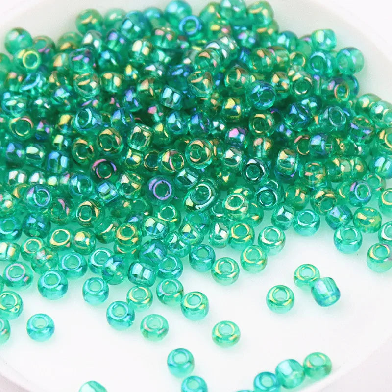 A pile of small, vibrant green glass rice beads for DIY jewelry and crafting.