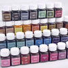 A collection of dark liquid dye powders in various shades including coffee, black, blue, green, and red for textile fabric dy