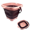 A pink and brown expandable sand bucket toy for toddlers with a handle.