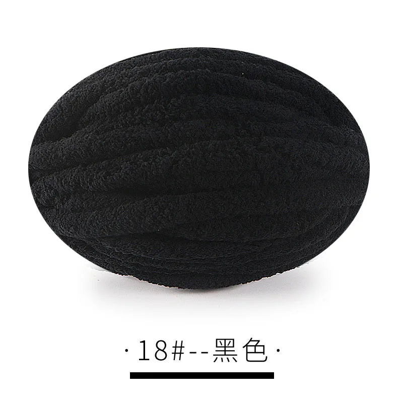 A ball of black chunky chenille yarn for hand knitting