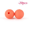 Two round, soft orange silicone beads are shown against a white background.