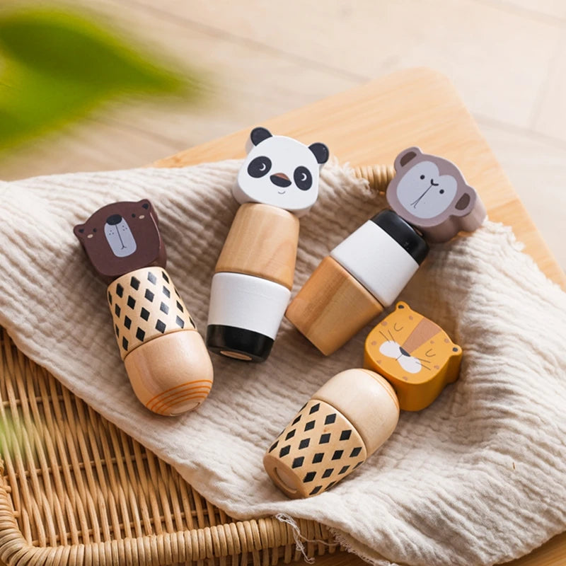 A set of wooden animal puzzle toys featuring panda, bear, and monkey figures resting on a beige linen cloth.