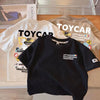 Black crew neck t-shirt with a Toycar design featuring various vehicles and the text Let's build Toycarworld together