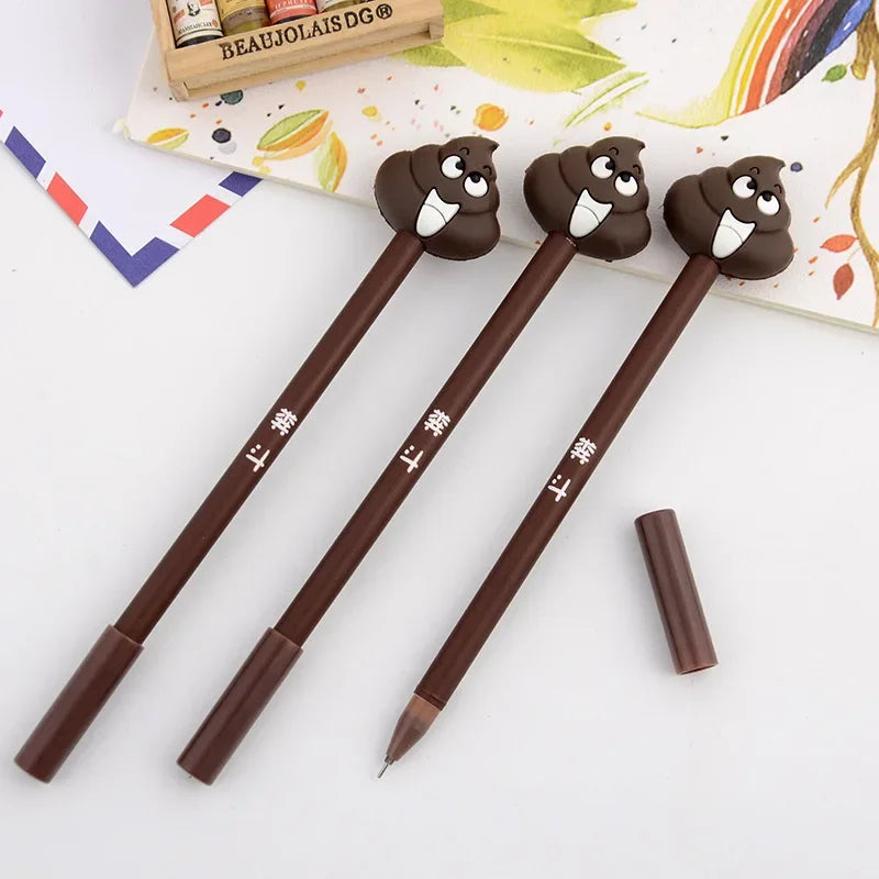 A set of three brown novelty cartoon poop gel pens with cute faces resting on a white surface.