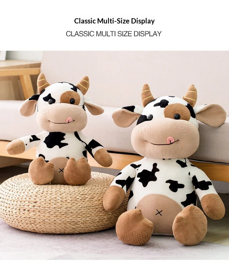 A classic multi-size display featuring two plush cow stuffed animals in black and white against a light background.