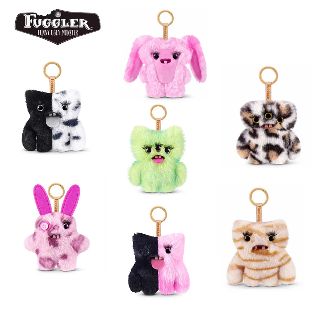 A collection of plush alien keychains featuring various colors and patterns including pink, black, white, and green.