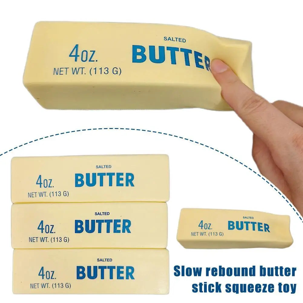 A hand holds a yellow butter stick fidget toy with the label 4oz Butter Net Wt 113 G.