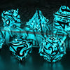 A set of polyhedral dice with a glow-in-the-dark effect resting on a dark surface.