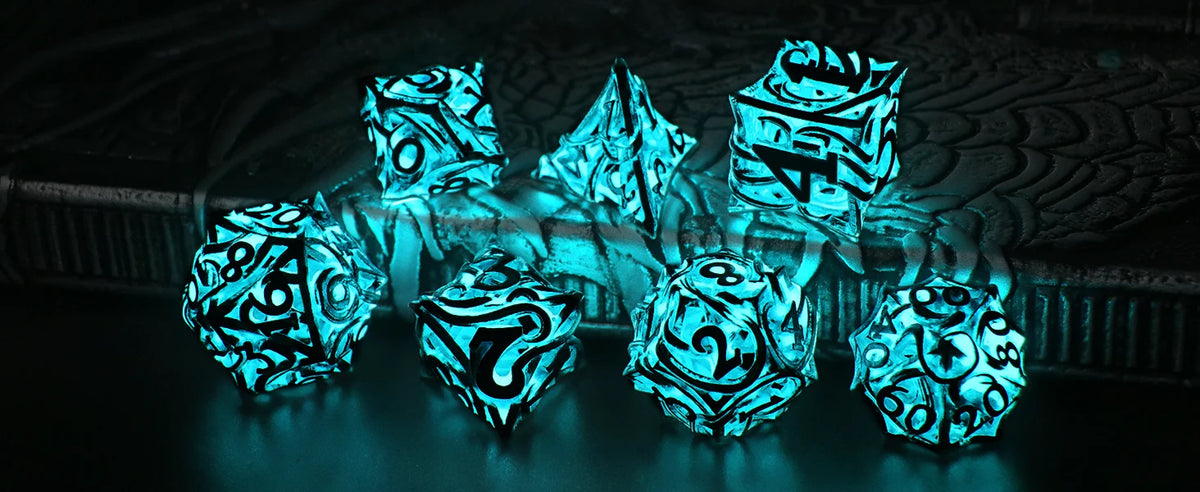 A set of polyhedral dice with a glow-in-the-dark effect resting on a dark surface.