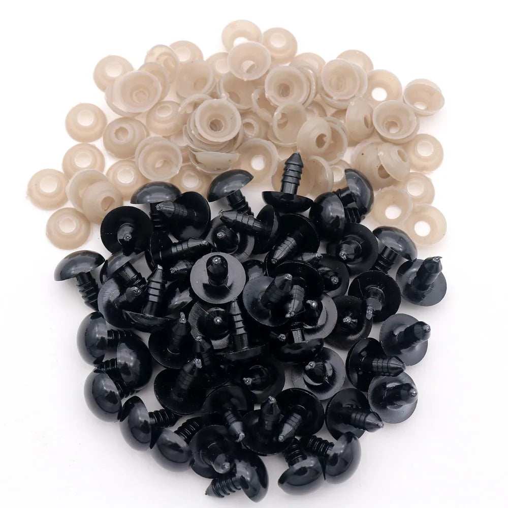 A pile of black plastic safety eyes with washers for crafting and stuffed animals