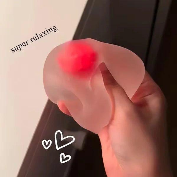 A hand is squeezing a pink squishy stress ball with a red center, labeled as super relaxing.