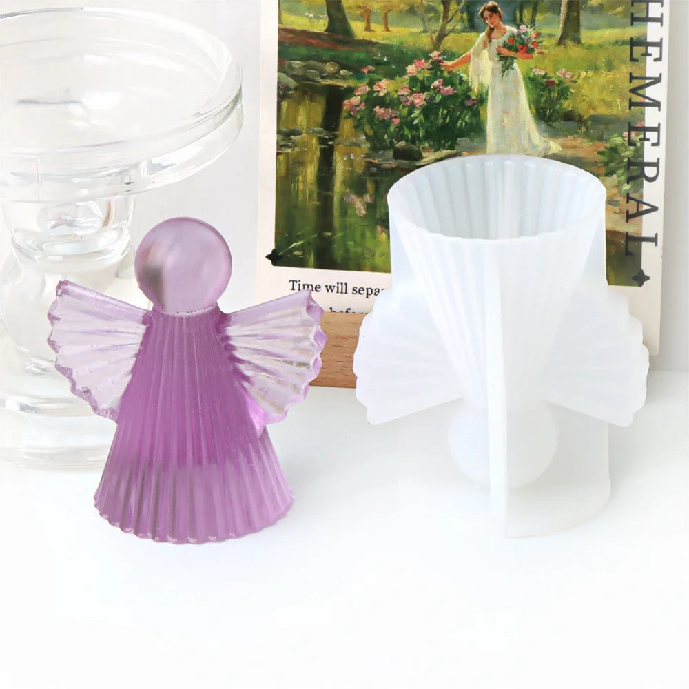 A purple silicone mold shaped like a cherub angel is displayed next to a white version.