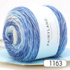 Blue gradient yarn in a skein displayed on a light blue background.