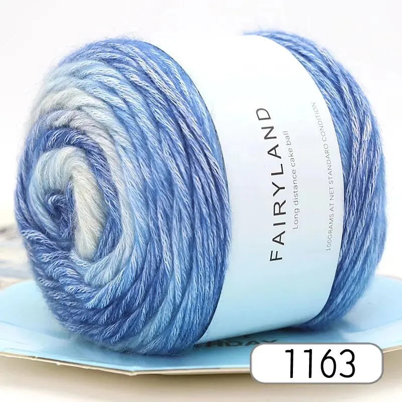 Blue gradient yarn in a skein displayed on a light blue background.