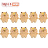 A set of ten cute beige capybara plush keychains or bag charms with colorful accents.