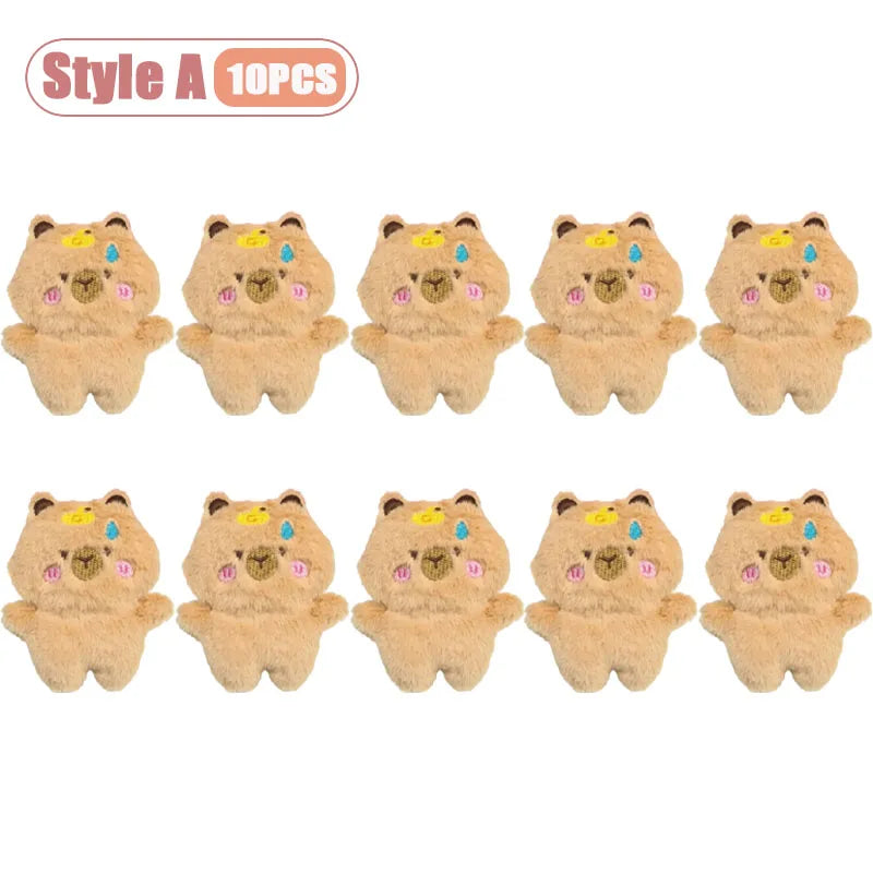 A set of ten cute beige capybara plush keychains or bag charms with colorful accents.