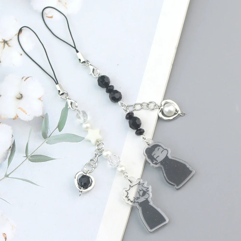 Silver and black anime-inspired keychain with removable charm featuring a character silhouette.