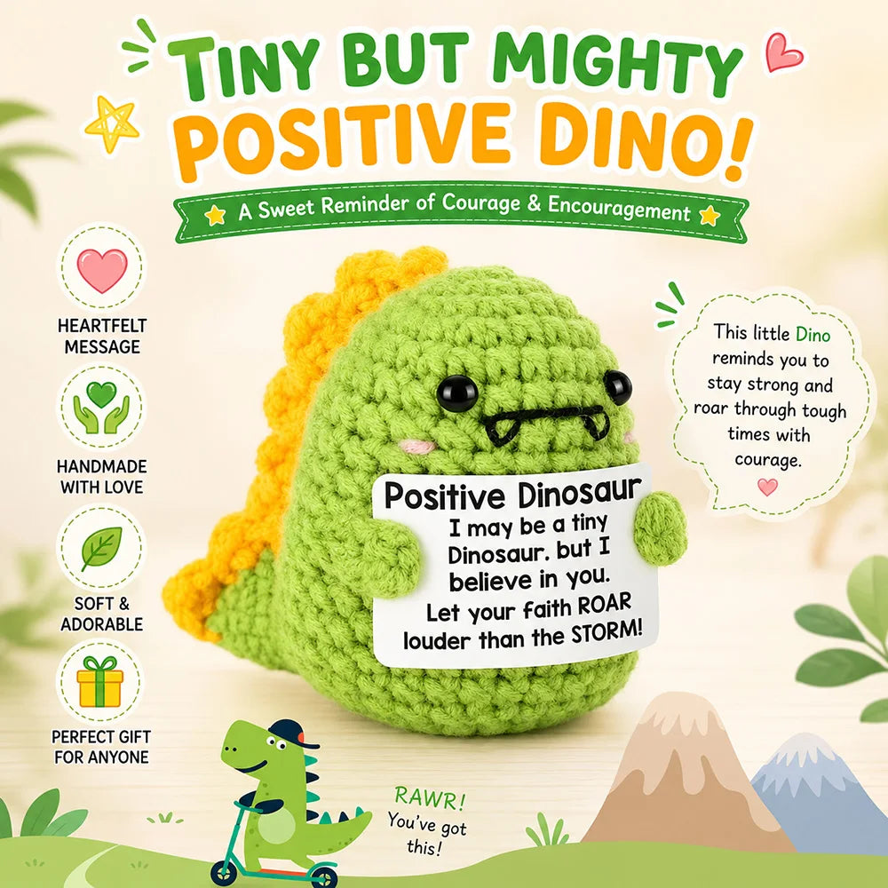 A handmade crochet dinosaur doll in green and yellow with a motivational card encouraging courage.