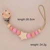 A wooden pacifier clip featuring silicone beads and a star shape on a leather cord.