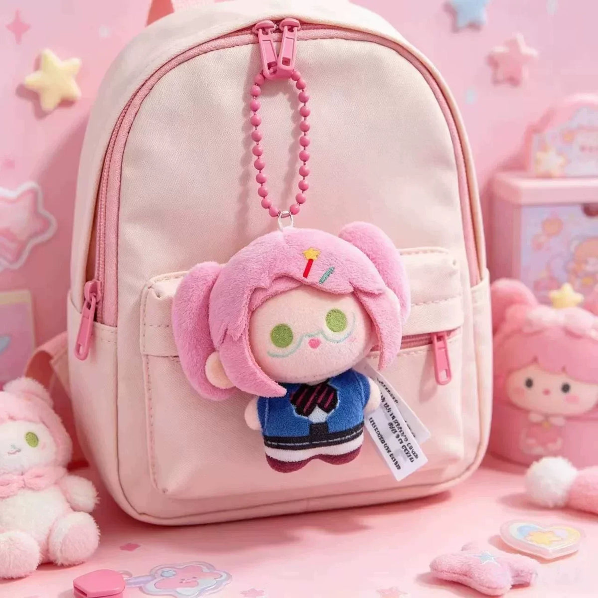 A pink backpack featuring a small plush charm of a character with pink hair and a blue outfit.