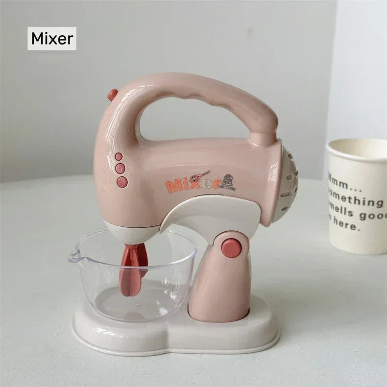 A pink mixer appliance with a handle and a clear glass bowl is shown on a white surface.