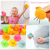 Assorted mini silicone rubber ducks in various colors are shown being pinched to make a sound.