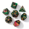A set of seven polyhedral acrylic dice showing various numbers and colors like green, purple, and red.