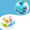 A blue wind-up caterpillar toy with large eyes and a smiling face is shown in two views.