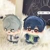 A cute plush doll of an anime character with blue hair and large red eyes sitting on white fluffy material.