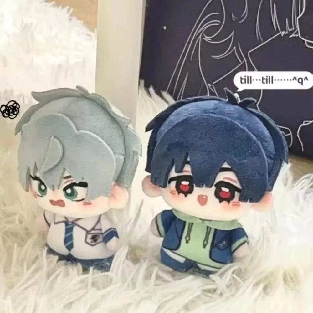 A cute plush doll of an anime character with blue hair and large red eyes sitting on white fluffy material.