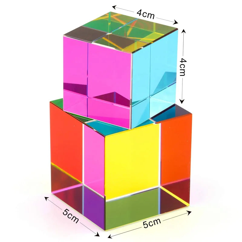 A colorful optical color cube prism with transparent sides and a larger base, showing various bright colors.