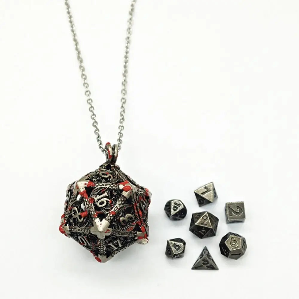 A silver chain necklace with a pendant storage case shaped like a polyhedron and several metal dice.