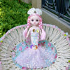 A pink mermaid doll with sparkly hair and a tulle dress is displayed in a woven basket.