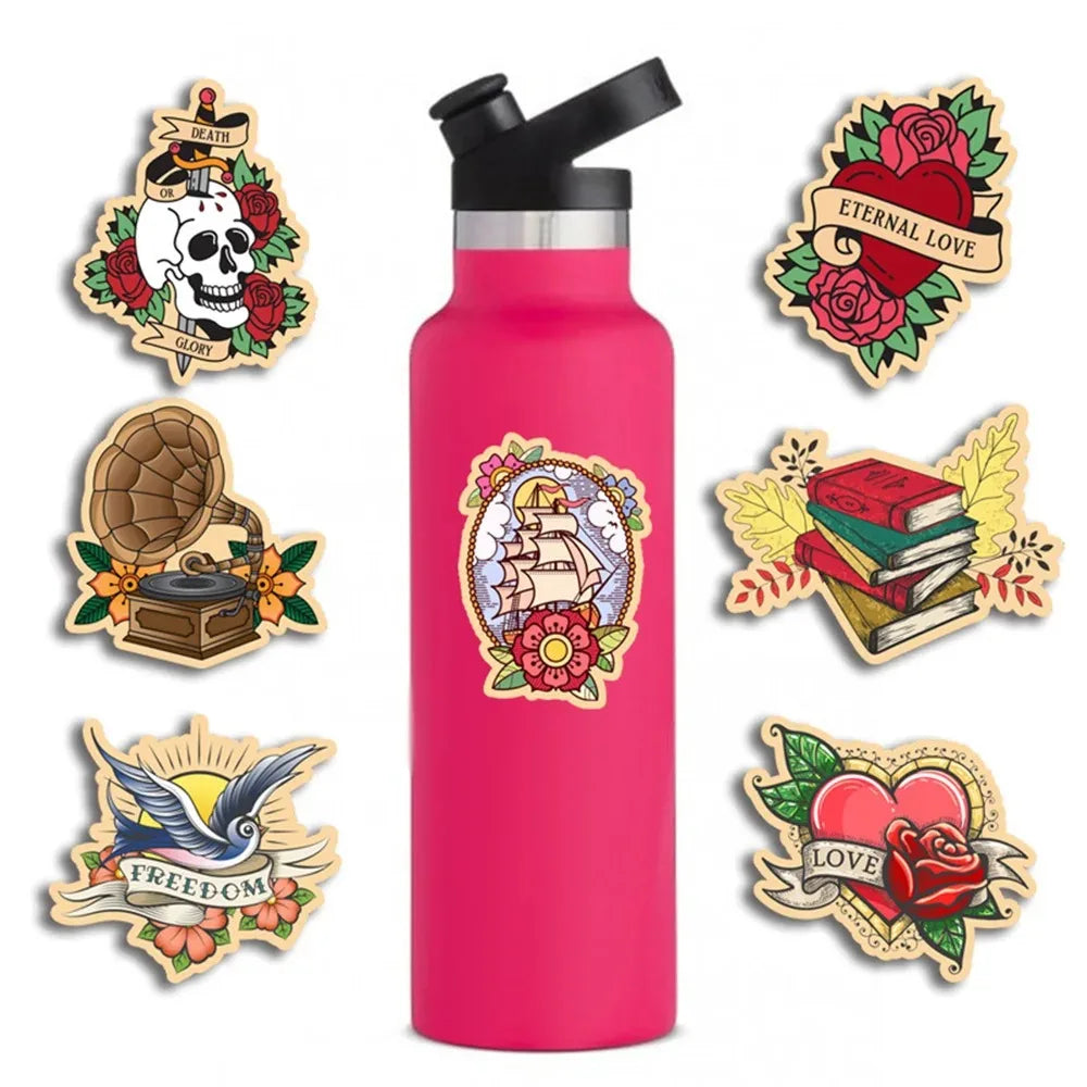 A pink water bottle featuring various retro tattoo cartoon stickers including skull, heart, book, and freedom themes.